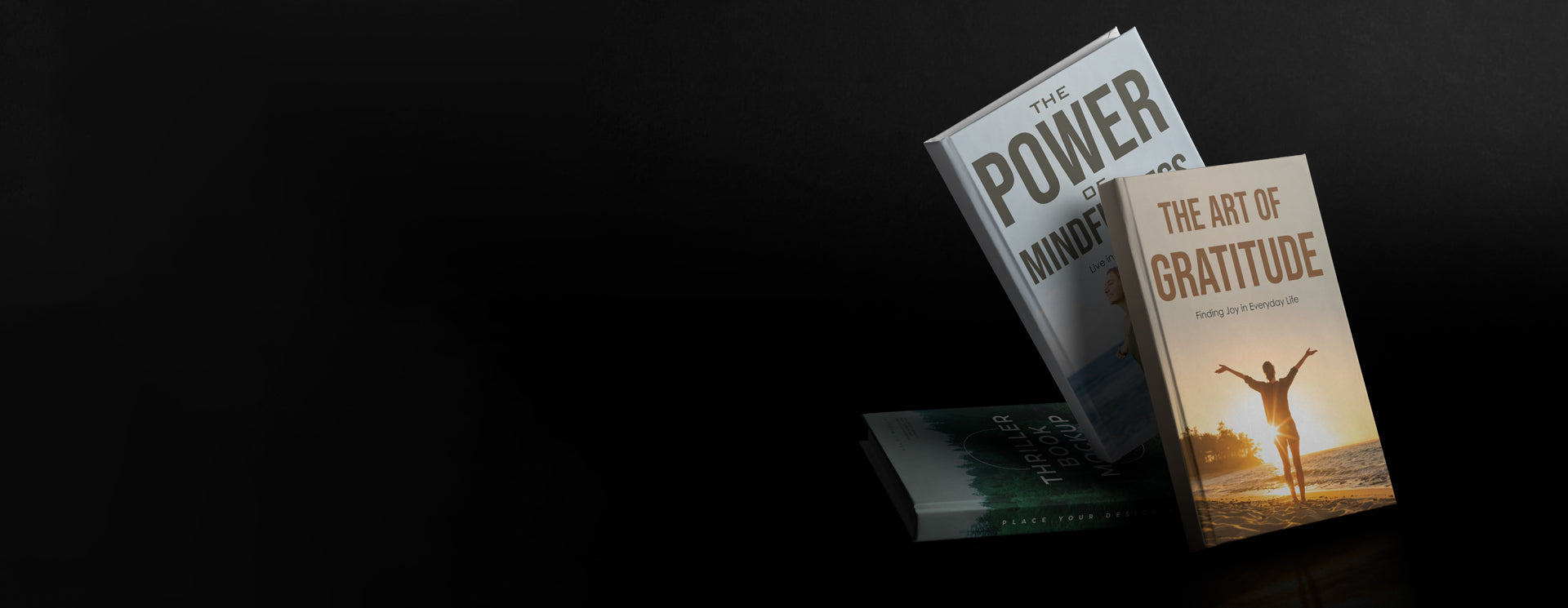 Two books titled 'Power of Now' and 'The Art of Gratitude' on a dark background
